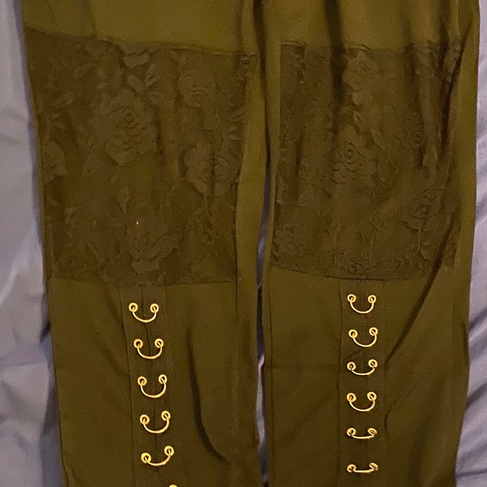 NEW. Black pants with gold hoops on legs.